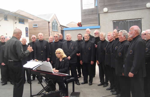 Polperro Fishermen's Choir performing on the fish quay at Looe